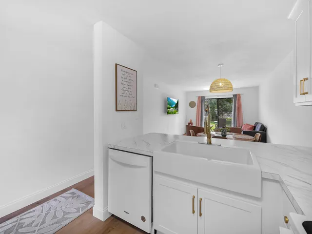 a kitchen with sink and mirror