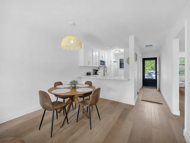 a view of a dining room with furniture and wooden floor