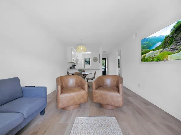 a living room with furniture and a potted plant