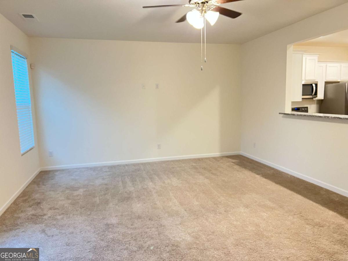 2678 Paxton Place Decatur, GA 30034 - Photo 10 of 22 an empty room with a chandelier fan and windows