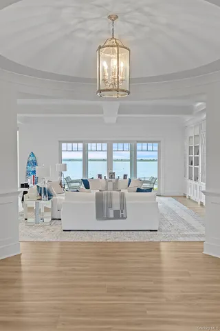 a kitchen with a refrigerator a stove a sink dishwasher and a dining table with wooden floor