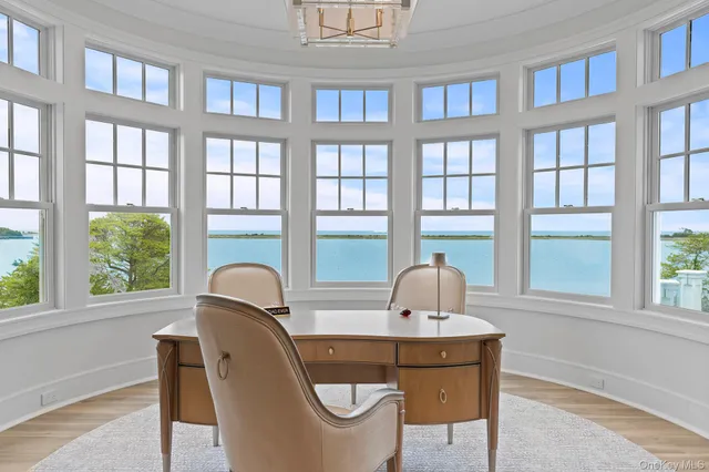 a living room with couches and kitchen view