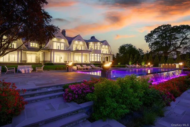 an aerial view of a house with a garden and lake view