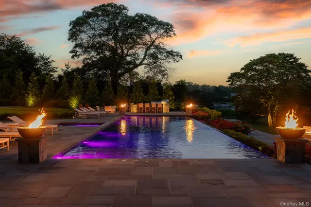 a front view of residential houses with yard and green space