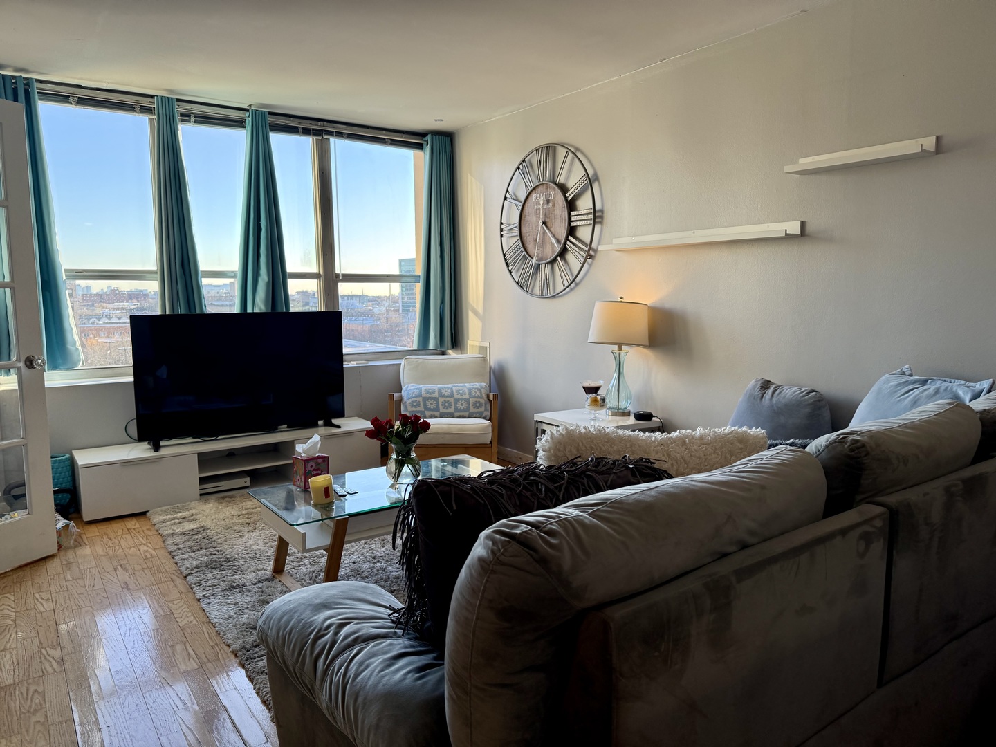655 West Irving Park Road, Unit 707 Chicago, IL 60613 - Photo 4 of 13 a living room with furniture and a flat screen tv