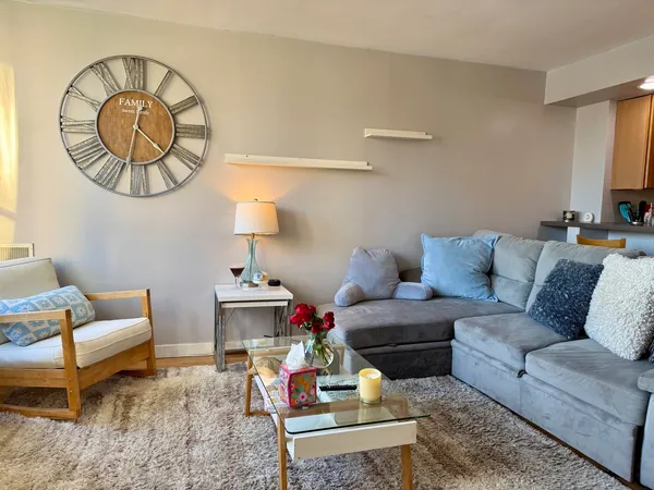 a living room with furniture a table and a potted plant