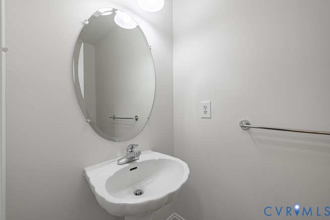 6118 Springwood Road Chester, VA 23831 - Photo 18 of 38 Pedestal sink with chrome faucet, an oval frameles