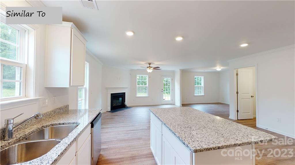 1118 Baileys Chapel Road Advance, NC 27006 - Photo 4 of 10 a large kitchen with granite countertop a sink and a stove