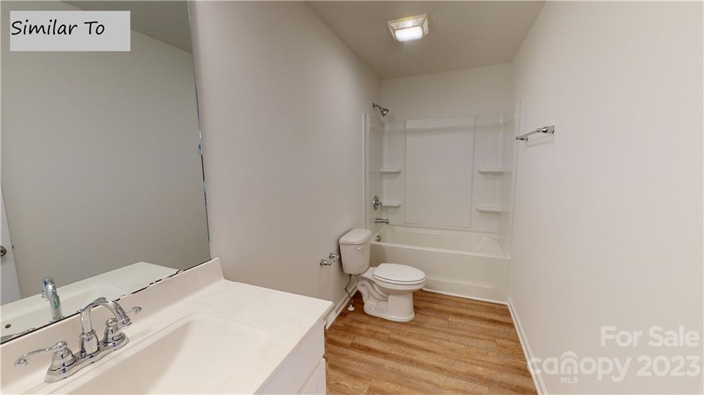 1118 Baileys Chapel Road Advance, NC 27006 - Photo 8 of 10 a bathroom with a sink toilet a mirror and shower