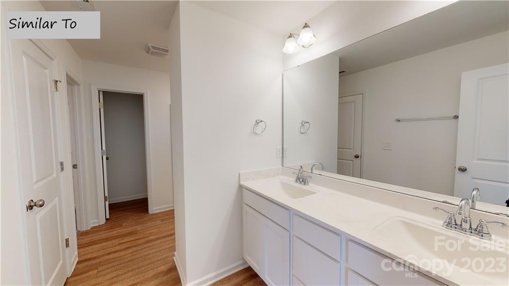 1118 Baileys Chapel Road Advance, NC 27006 - Photo 9 of 10 a bathroom with a double vanity sink and a mirror