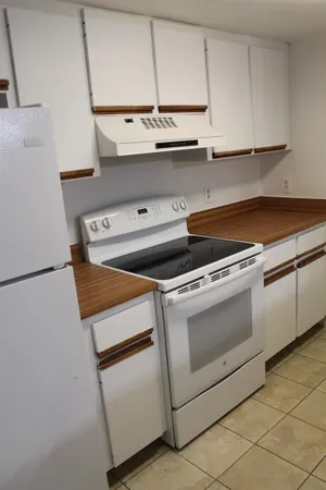 a stove top oven sitting inside of a kitchen