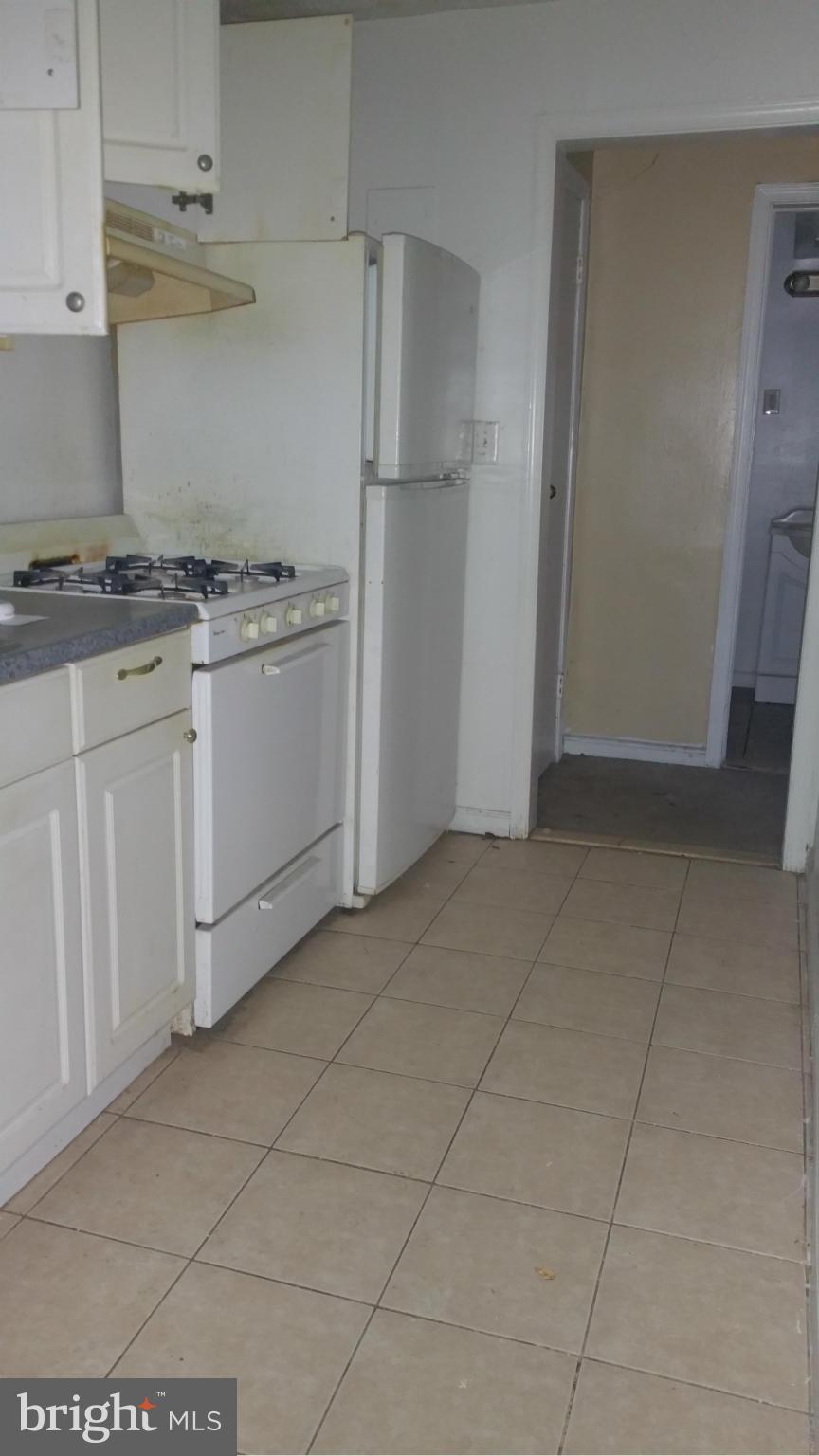 1617 Butler Street Southeast Washington, DC 20020 - Photo 12 of 16 a kitchen with white cabinets and white appliances
