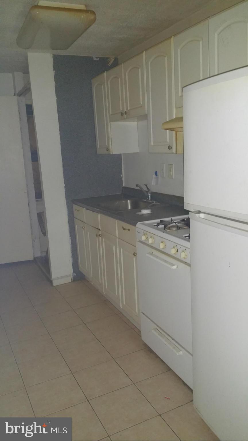 1617 Butler Street Southeast Washington, DC 20020 - Photo 13 of 16 a kitchen with granite countertop white cabinets and white appliances