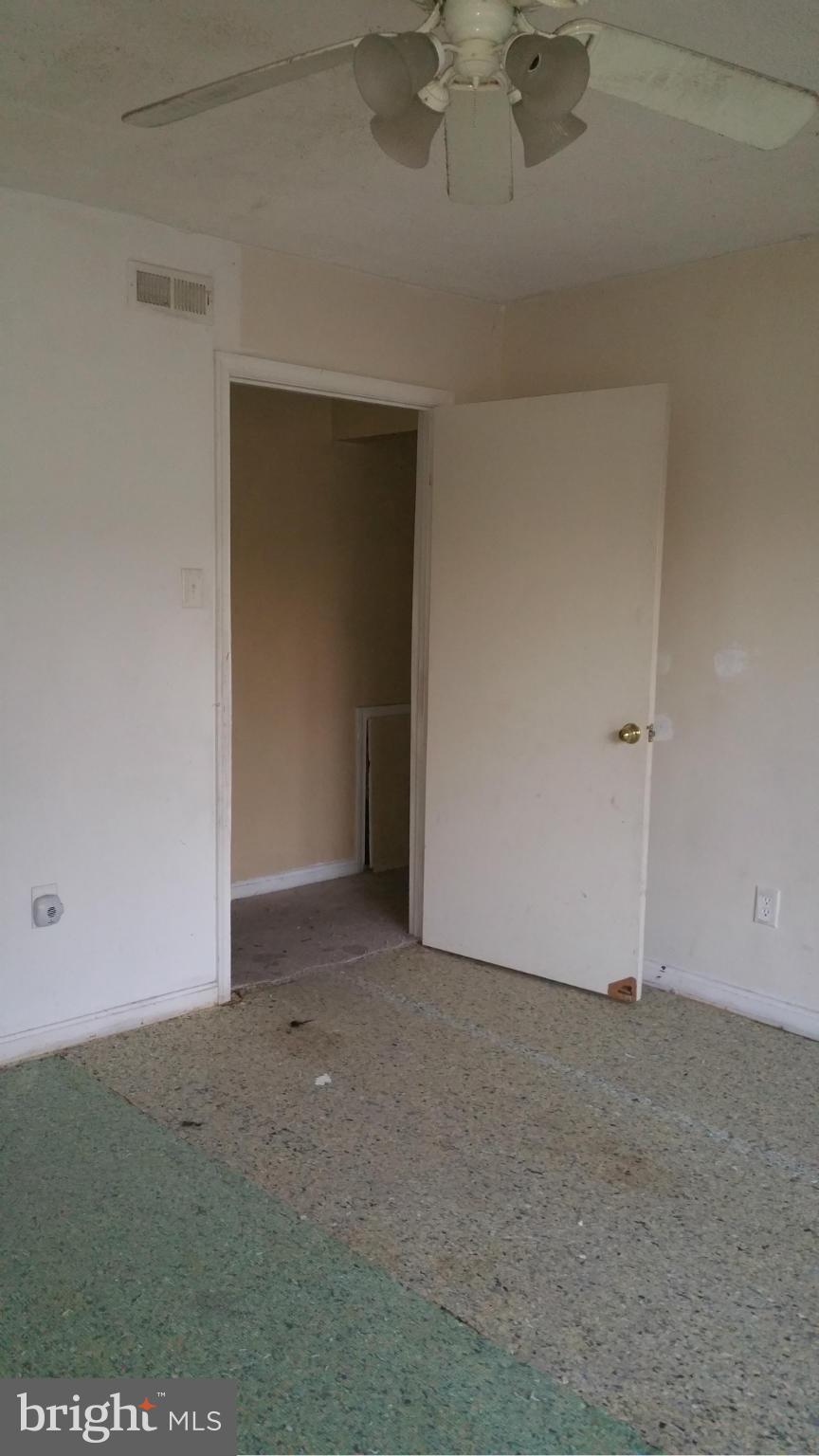 1617 Butler Street Southeast Washington, DC 20020 - Photo 15 of 16 an empty room with a ceiling fan and carpet