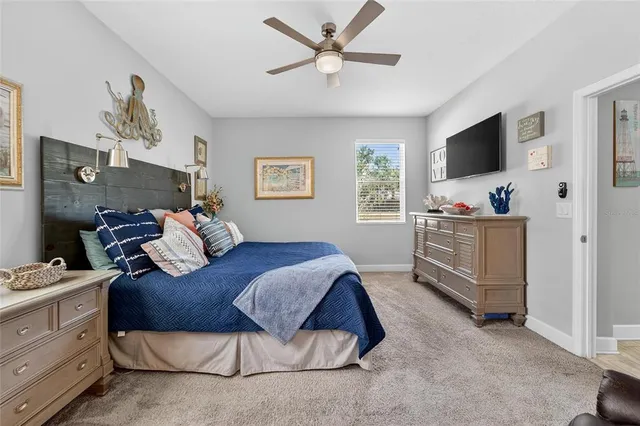 a living room with furniture a window and a flat screen tv