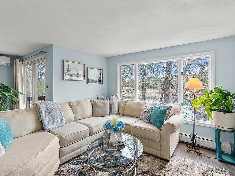 15 Riverview Avenue, Unit D Mashpee, MA 02649 - Photo 6 of 33 a living room with furniture and a large window