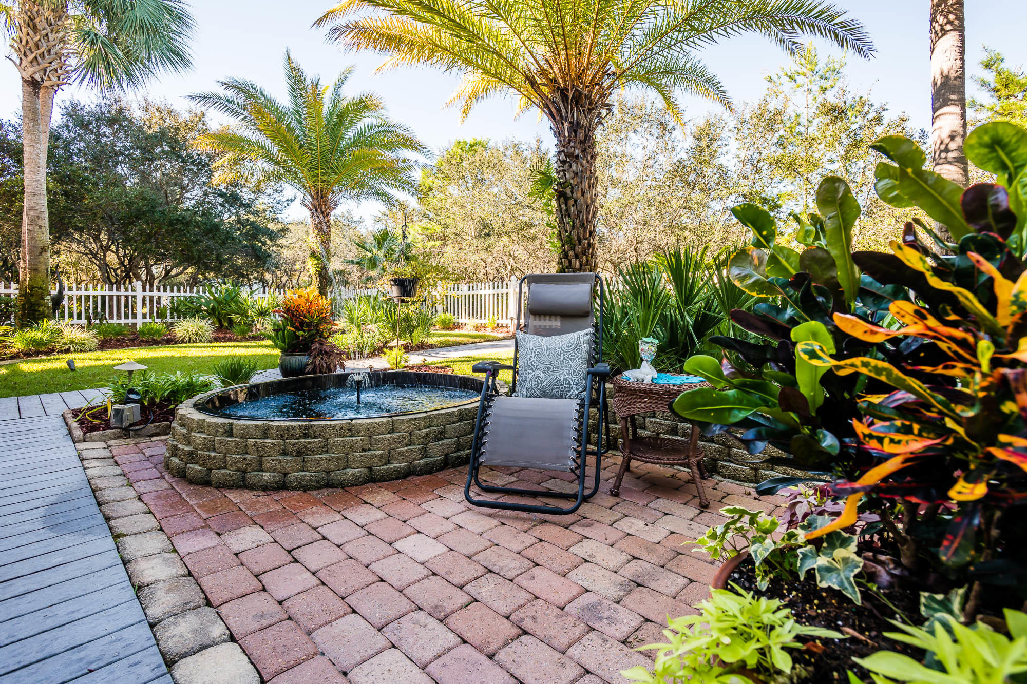 260 Old Beach Road Santa Rosa Beach, FL 32459 - Photo 54 of 75 a view of a backyard with fountain plants and palm trees