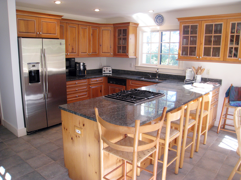 94 Miacomet Road Nantucket, MA 02554 - Photo 8 of 18 a kitchen with granite countertop kitchen island stainless steel appliances a refrigerator a sink a stove a table and chairs