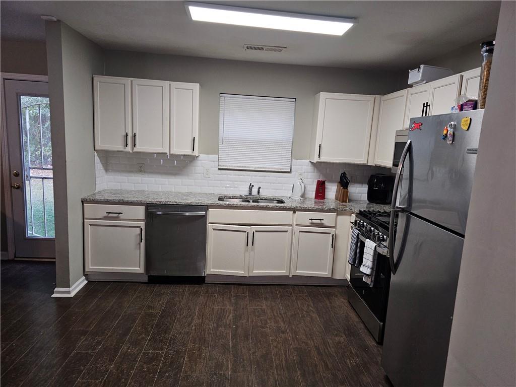 3503 Ebb Circle Fairburn, GA 30213 - Photo 7 of 12 a kitchen with a refrigerator sink and cabinets