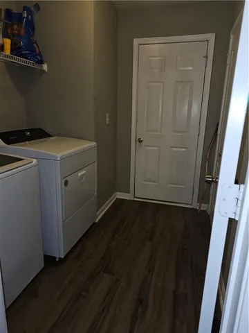 a utility room with wooden floor and cabinet