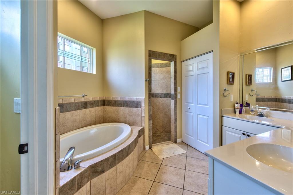 3748 Kent Drive Naples, FL 34112 - Photo 18 of 30 a bathroom with a tub and a sink
