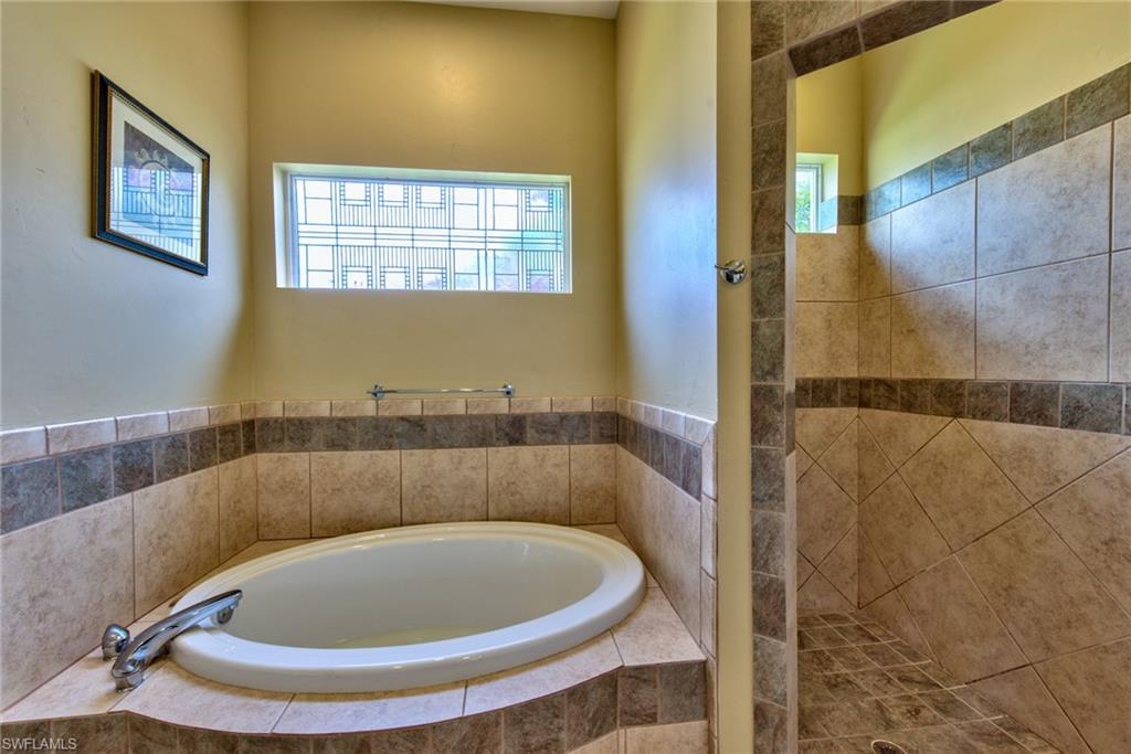 3748 Kent Drive Naples, FL 34112 - Photo 19 of 30 a bathroom with a sink and bathtub