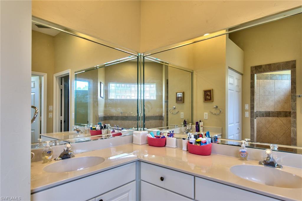 3748 Kent Drive Naples, FL 34112 - Photo 20 of 30 a bathroom with a sink and a mirror