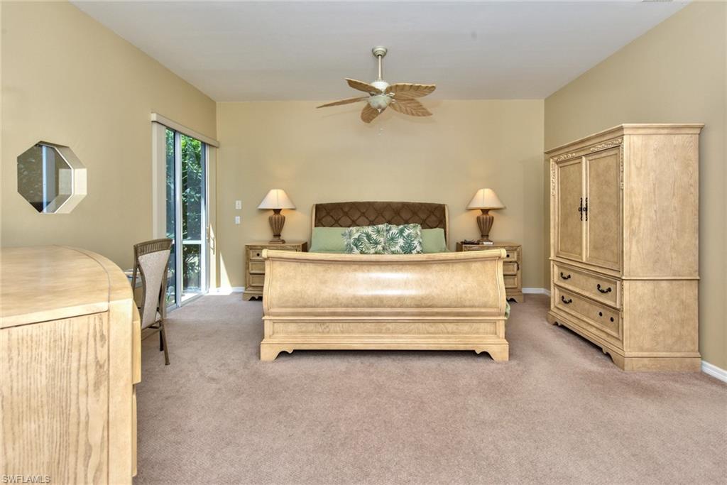 3748 Kent Drive Naples, FL 34112 - Photo 21 of 30 a bed room with a bed and a chandelier