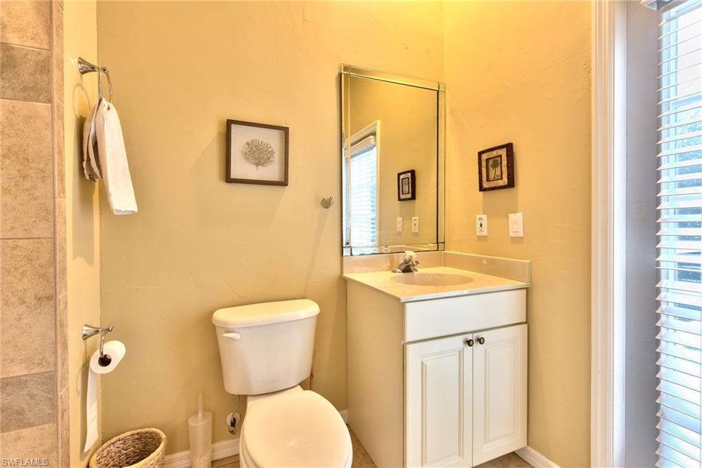 3748 Kent Drive Naples, FL 34112 - Photo 29 of 30 a bathroom with a toilet sink and mirror