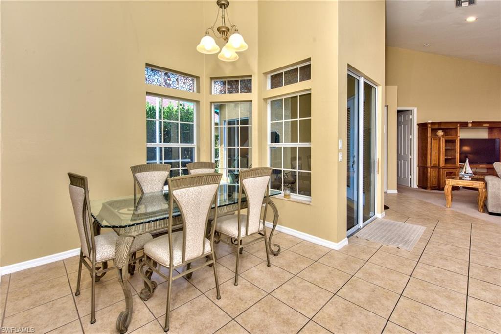 3748 Kent Drive Naples, FL 34112 - Photo 4 of 30 a view of a dining room with furniture and chandelier