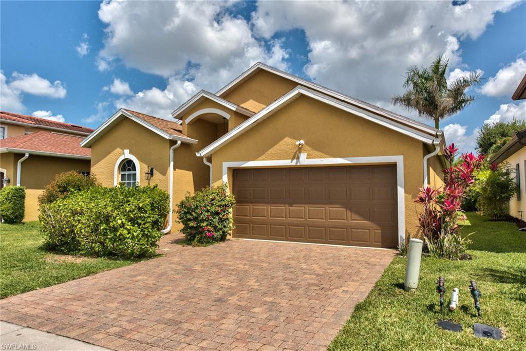 3748 Kent Drive Naples, FL 34112 - Photo 7 of 30 a front view of a house with a yard and garage