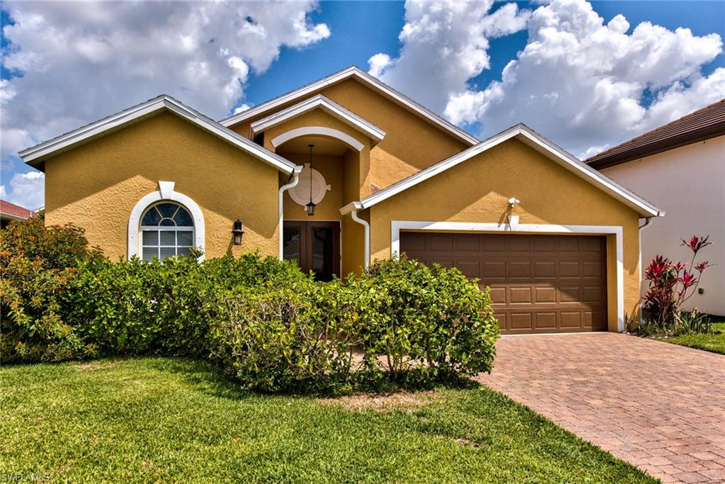 3748 Kent Drive Naples, FL 34112 - Photo 8 of 30 a front view of a house with garden