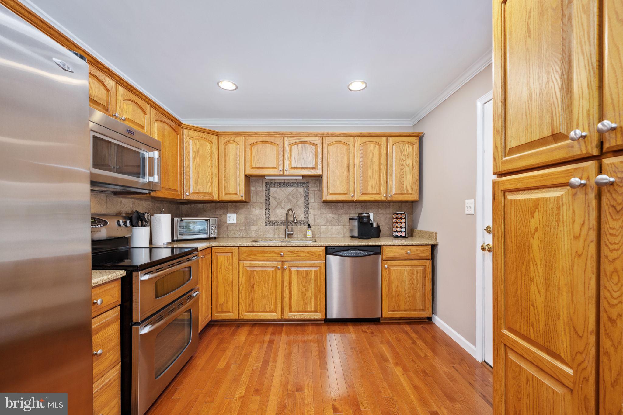 21 Waterview Point Colonial Beach, VA 22443 - Photo 7 of 23 a kitchen with stainless steel appliances granite countertop a stove a sink and a refrigerator