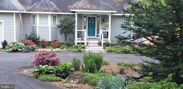 a front view of a house with a garden
