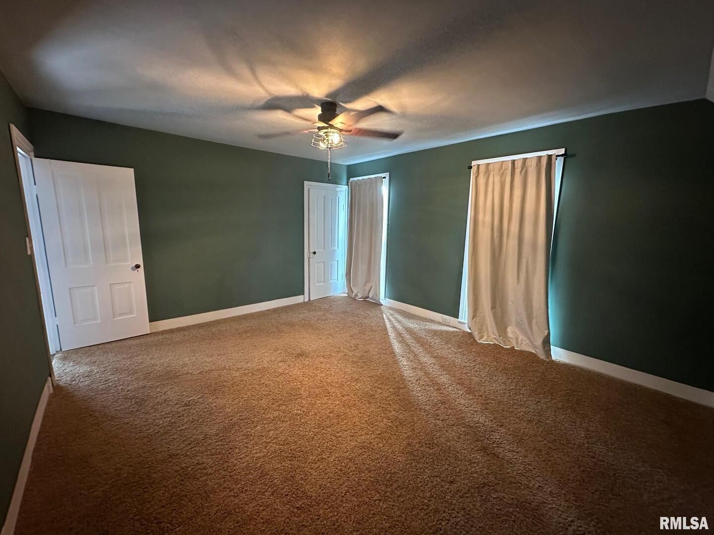 323 Lincoln Street Miles, IA 52064 - Photo 21 of 34 en empty room with windows and fan