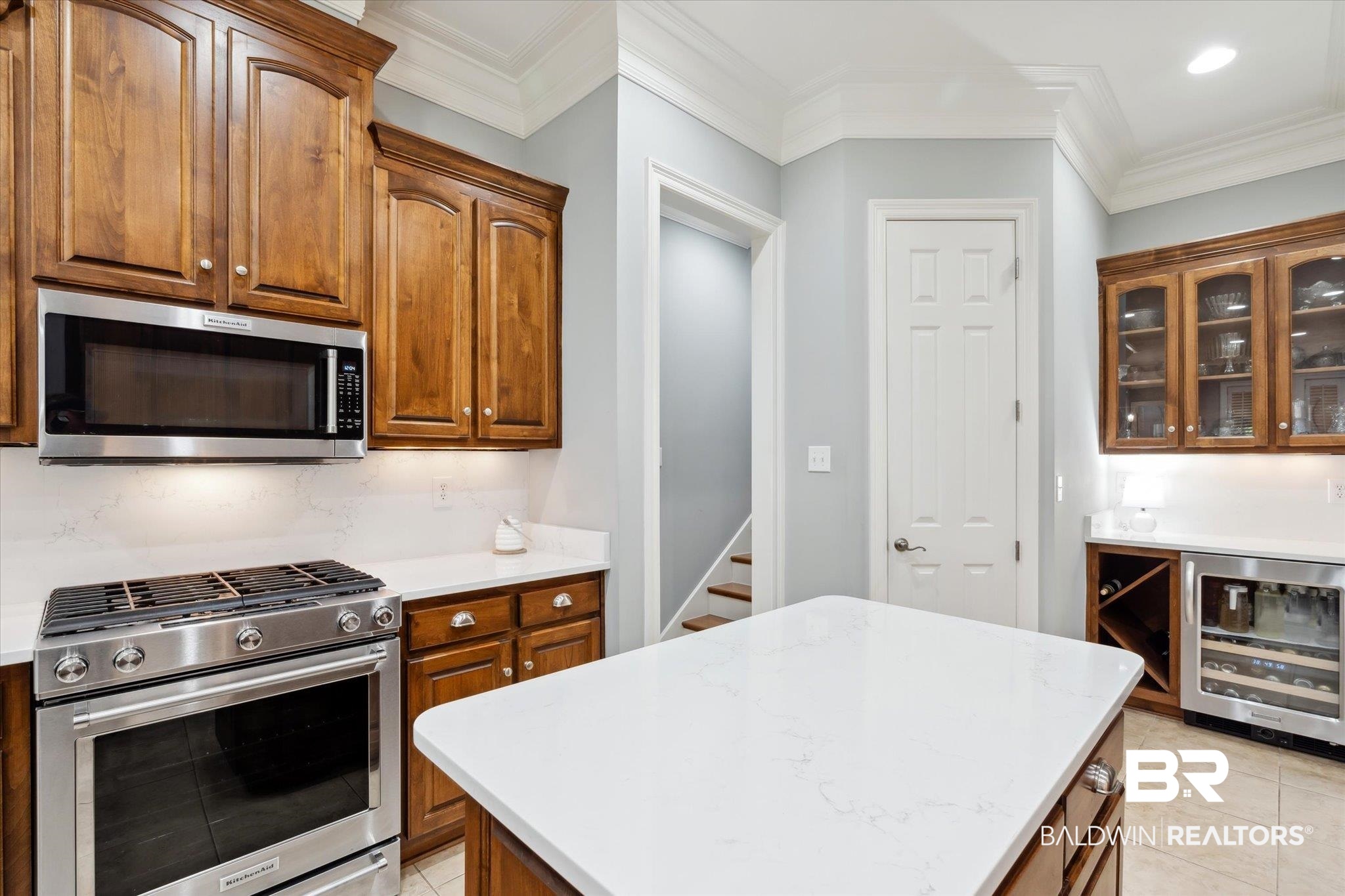 804 Country Club Road Mobile, AL 36609 - Photo 9 of 63 Kitchen with light tile patterned flooring, stainless steel appliances, ornamental molding, a center island, and wine cooler