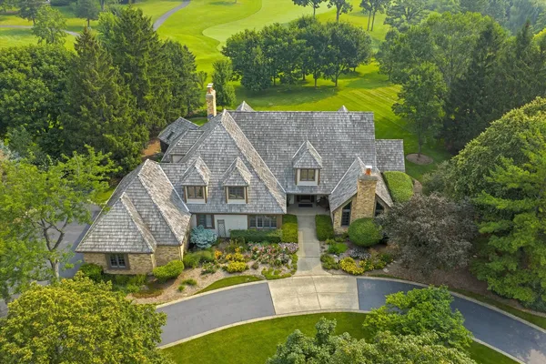 an aerial view of a house with a big yard