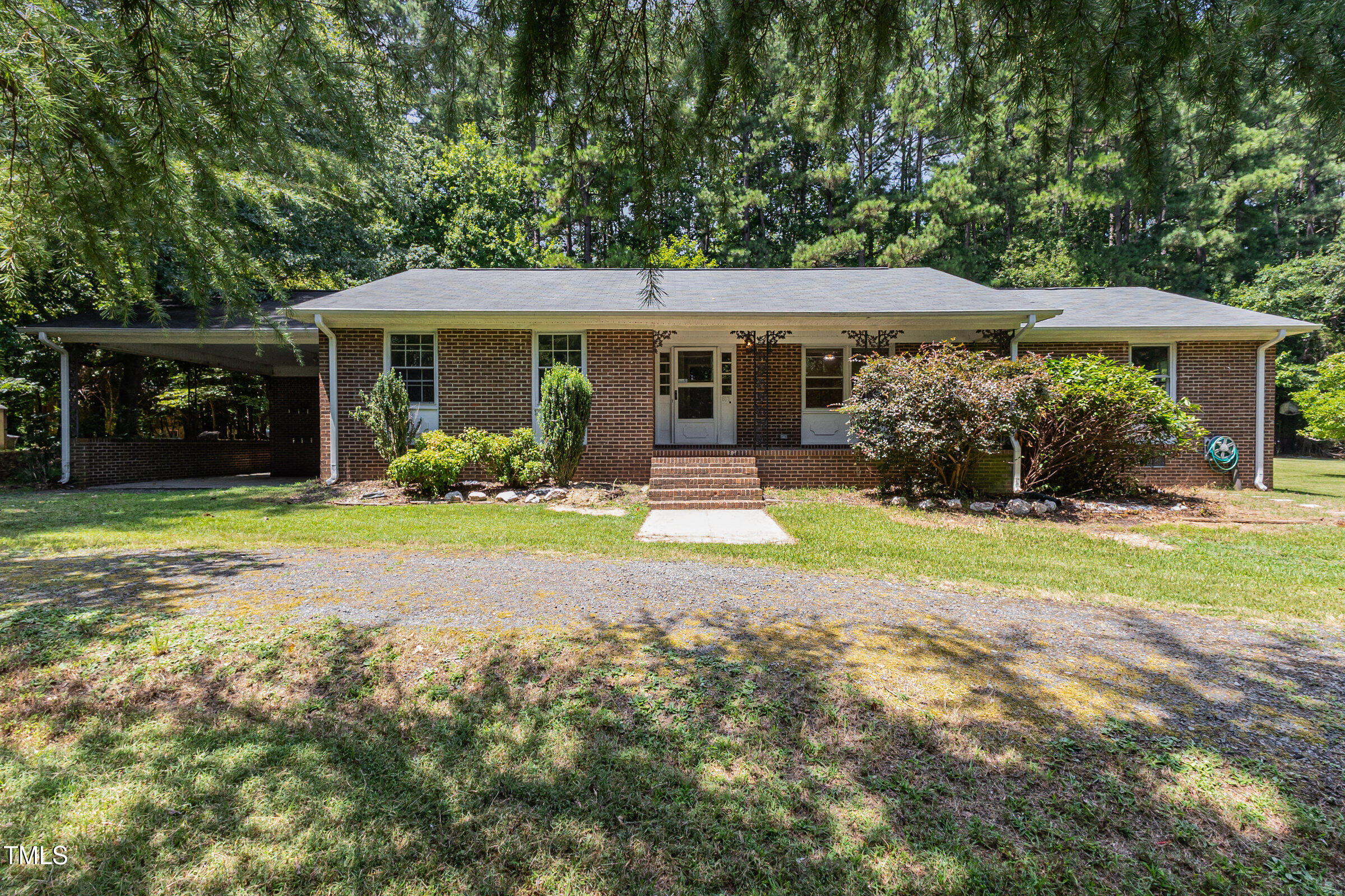 a view of a house with yard and sitting area