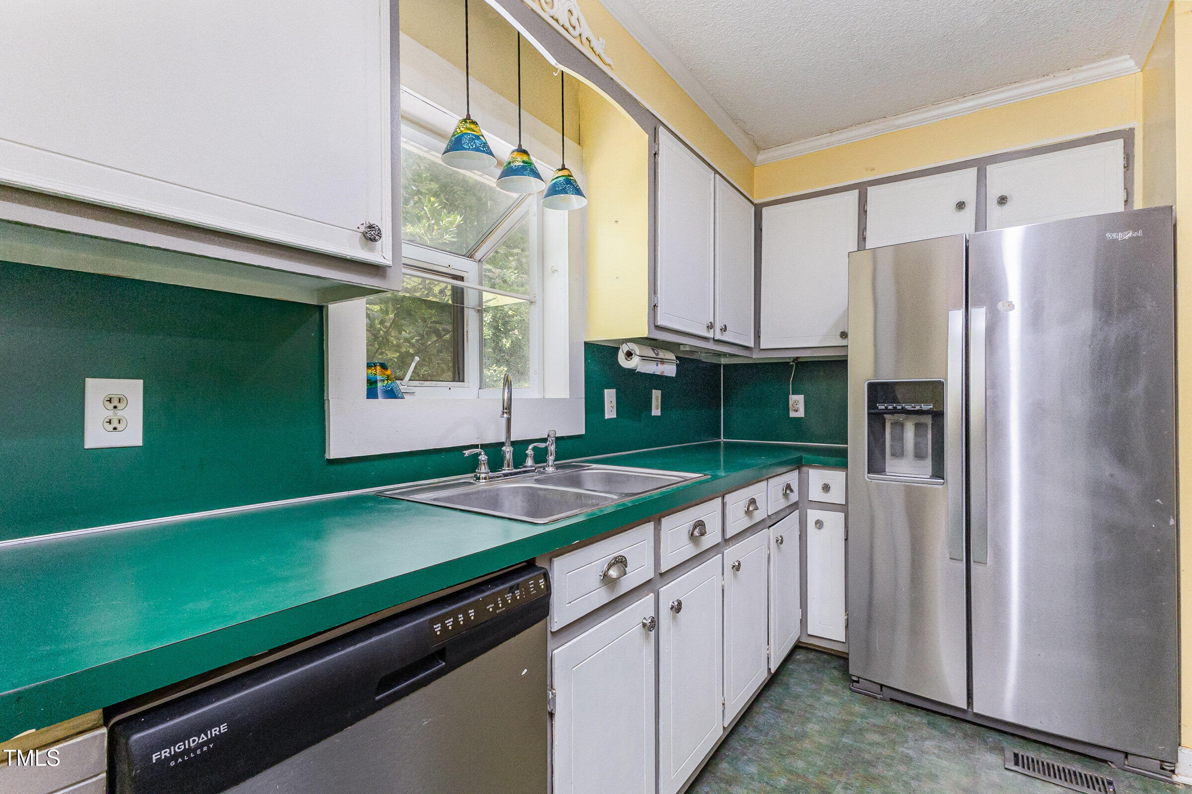 817 Bent Creek Road Bahama, NC 27503 - Photo 12 of 45 a kitchen with kitchen island a sink cabinets and refrigerator