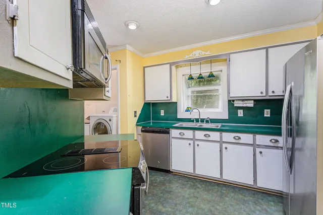a kitchen with a sink cabinets and window