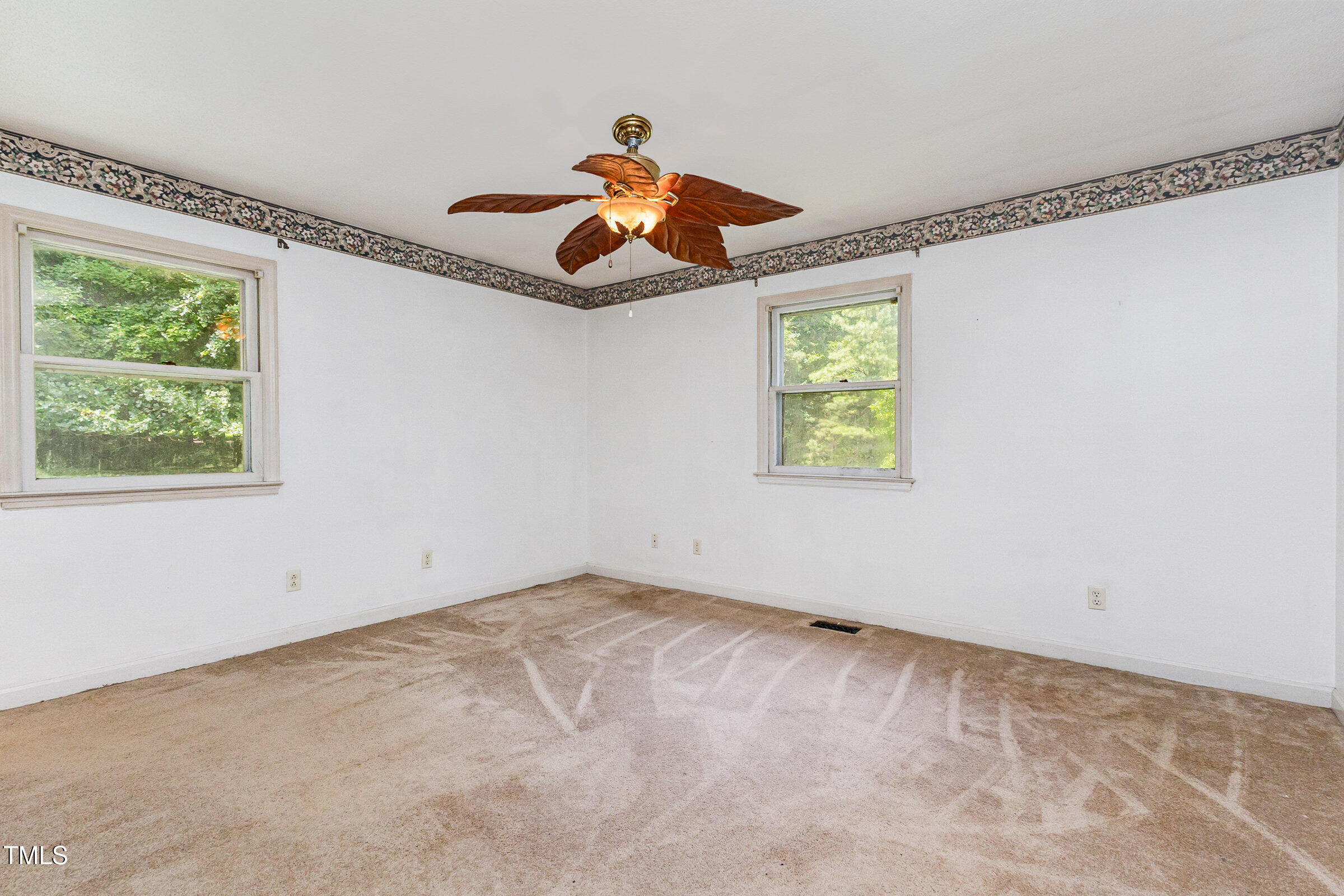 817 Bent Creek Road Bahama, NC 27503 - Photo 16 of 45 an empty room with windows and fan