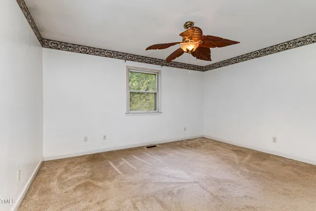 a view of a room with window and ceiling fan