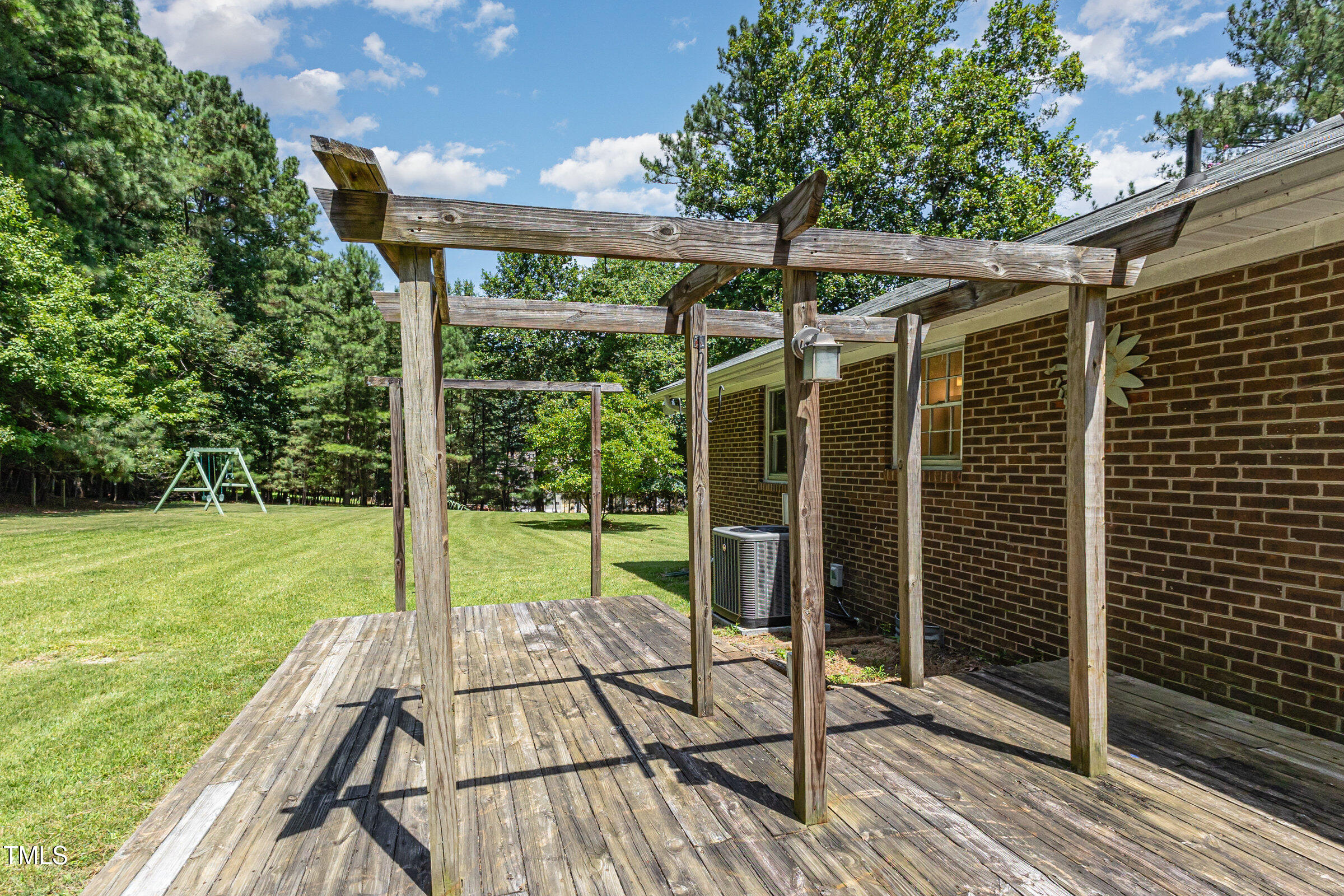 817 Bent Creek Road Bahama, NC 27503 - Photo 27 of 45 a backyard of a house with seating space and trees