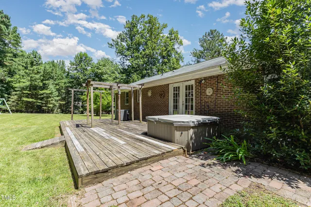 a view of a patio with table and chairs with wooden fence and plants