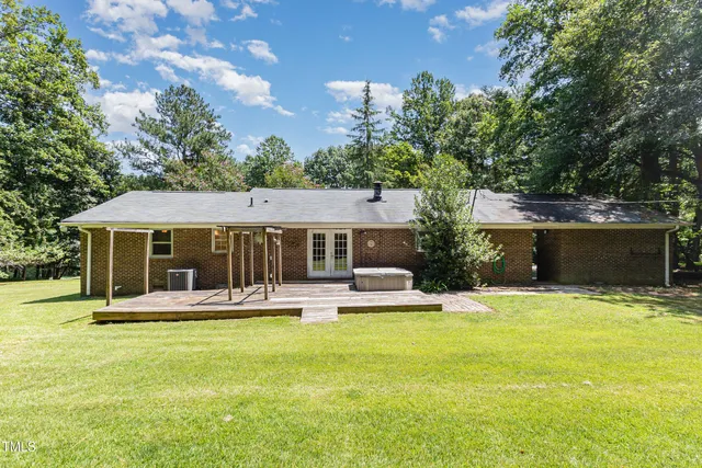 a view of a house with a yard patio and swimming pool