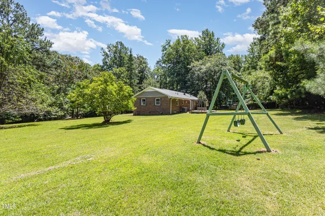 a view of a backyard with swimming pool