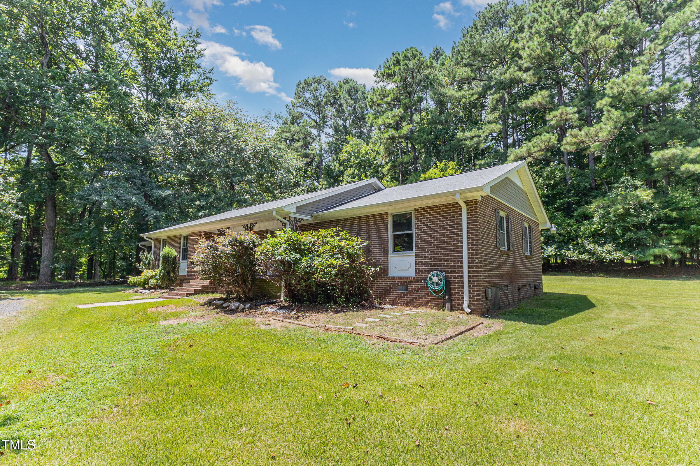 817 Bent Creek Road Bahama, NC 27503 - Photo 3 of 45 a view of a house with a yard and potted plants