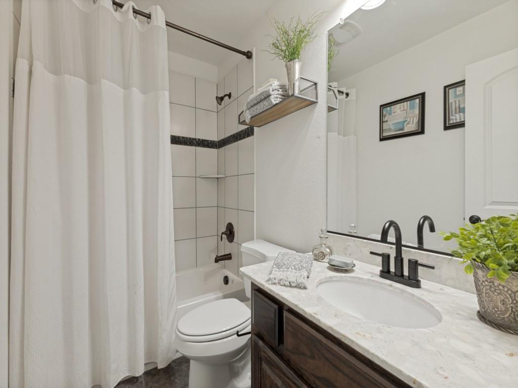 916 Redbird Lane Allen, TX 75013 - Photo 18 of 28 Guest bath just off of game room and media room hallway across from the guest bedroom which is split from the other two secondary bedrooms.