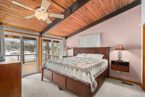 a bed sitting in a spacious bedroom next to a window
