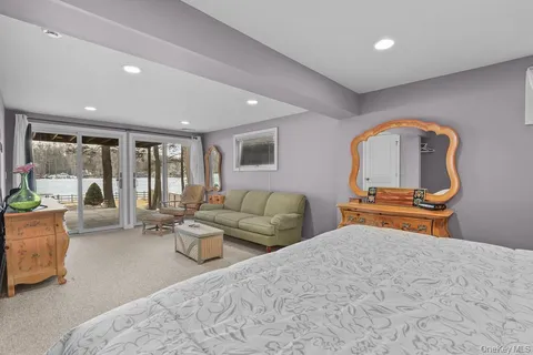 a bedroom with furniture and a large window